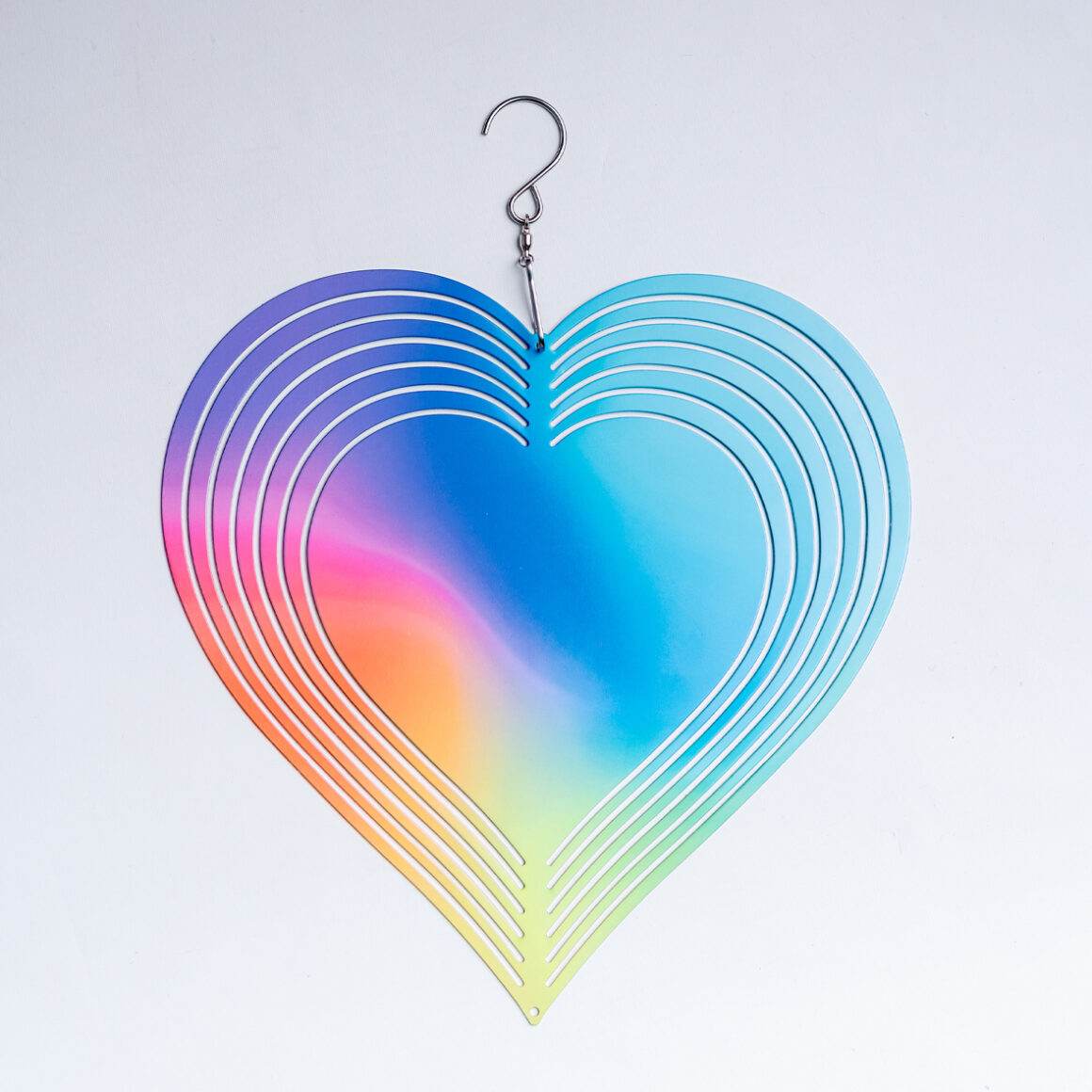 Egy szív alakú fém szélforgó látható, mely szivárvány színű. Széthajtogatható.